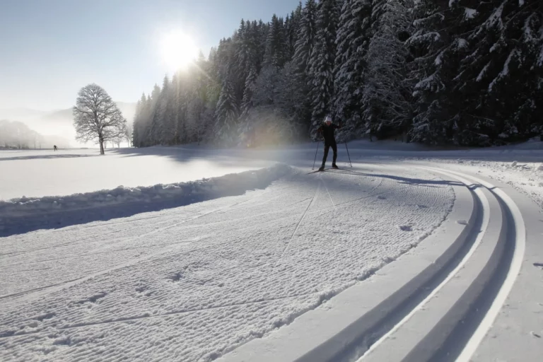 Cross-country skier on a groomed trail in winter Cross-country skier on a groomed trail in winter – winter holiday in Ramsau am Dachstein